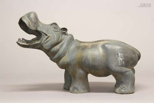 A BRONZE SCULPTURE OF A HIPPOPOTAMUS. A large sculptural fig...