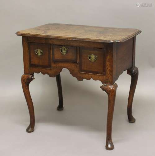 AN 18TH CENTURY OAK LOWBOY, the inlaid shaped rectangular to...
