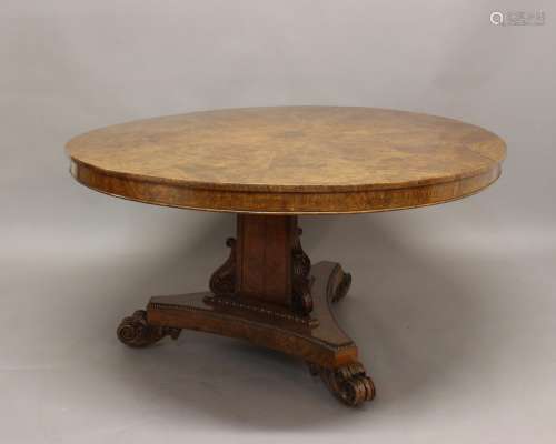A WILLIAM IV BURR OAK BREAKFAST TABLE. The circular top with...