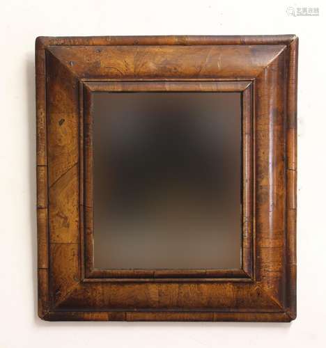 AN 18TH CENTURY WALNUT CUSHION MIRROR, the rectangular plate...