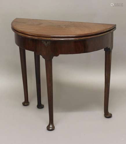 A GEORGE II MAHOGANY TEA TABLE, of demi-lune form on pad fee...