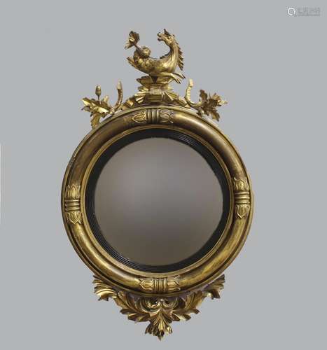 A REGENCY GILT WOOD CONVEX MIRROR, the circular convex mirro...