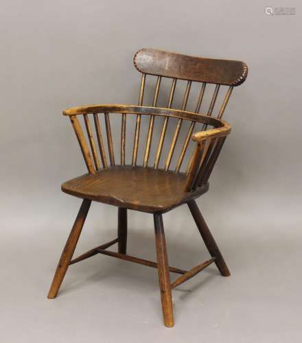 A PRIMITIVE LOW-BACKED WINDSOR ARMCHAIR. A primitive country...