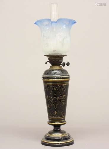 A VICTORIAN OIL LAMP AND SHADE. A Victorian oil lamp with a ...