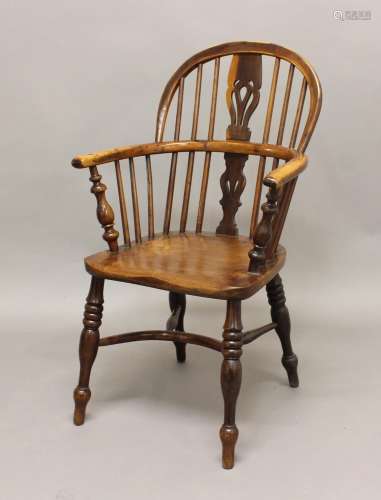 A YEW AND ELM WINDSOR CHAIR, the arched top above pierced va...