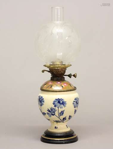 A VICTORIAN OIL LAMP AND SHADE. A Victorian oil lamp with a ...