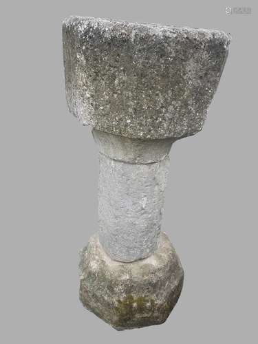 A CARVED STONE FONT OR BIRD BATH. A carved stone font or bir...