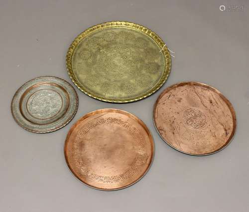 A LARGE EASTERN COPPER TRAY AND FOUR SIMILAR. A large copper...