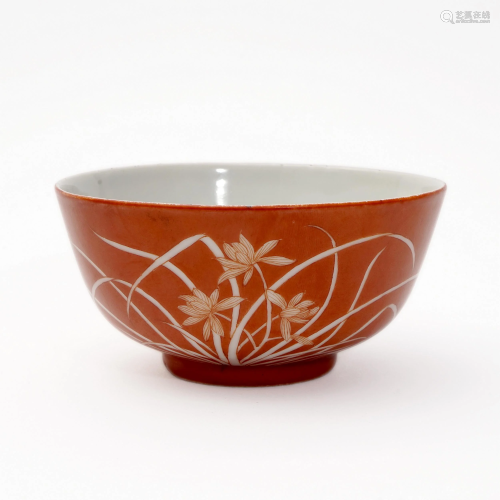 AN ALUM RED BOWL WITH WHITE ORCHID PATTERN
