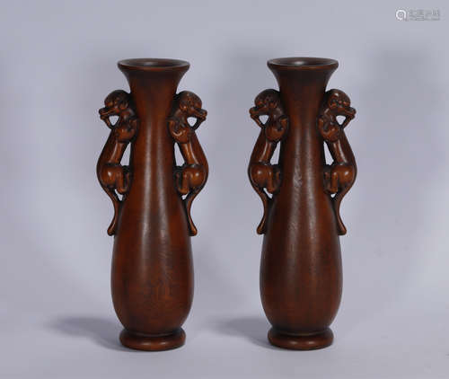 A pair of Qing style boxwood carved vases