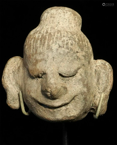 Early Mongolian clay head. Smile as wide as the world.