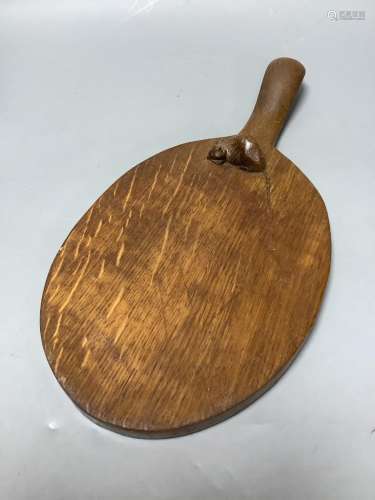 A 'Mouseman' carved wooden cheese board, length 37cm
