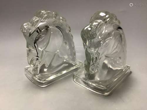 A pair of American press moulded glass horse head bookends, ...