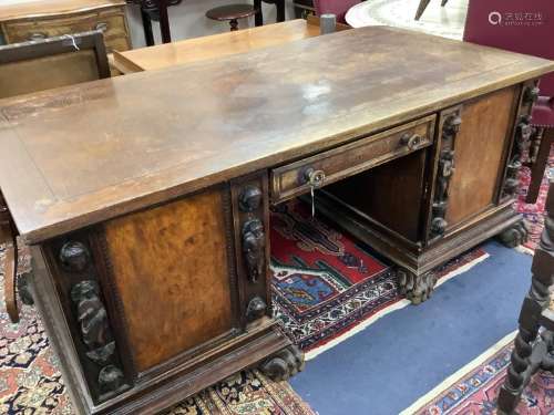 A large late 19th century oak and walnut kneehole desk, widt...