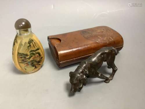 A bronze dog, a Chinese snuff bottle and a stamped leather c...