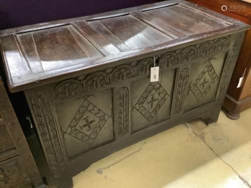 A late 17th / early 18th century carved panelled oak coffer,...