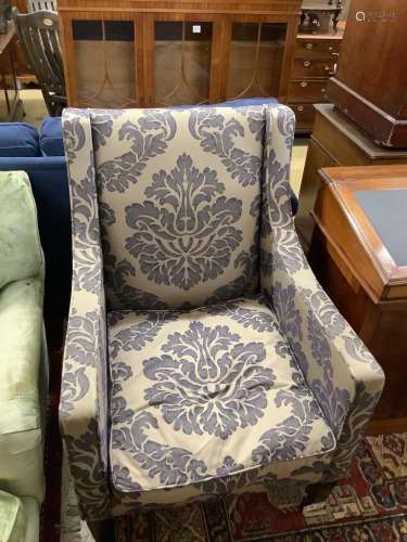 A contemporary armchair with silver/ blue patterned fabric, ...