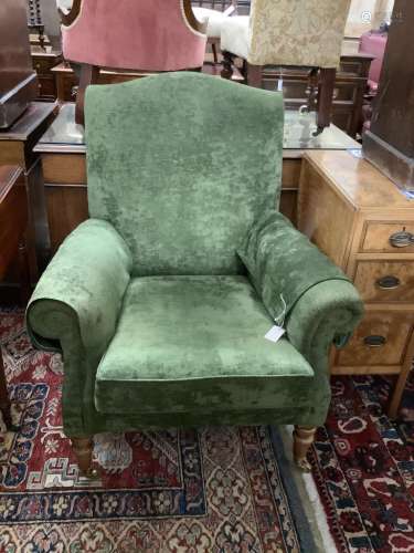 A Victorian style lounge armchair, with green upholstery, wi...