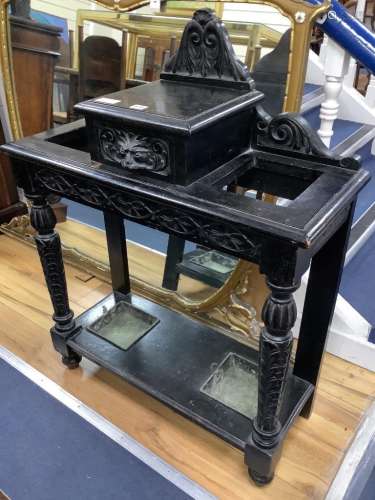 A late Victorian ebonised oak hallstand carved in Flemish st...