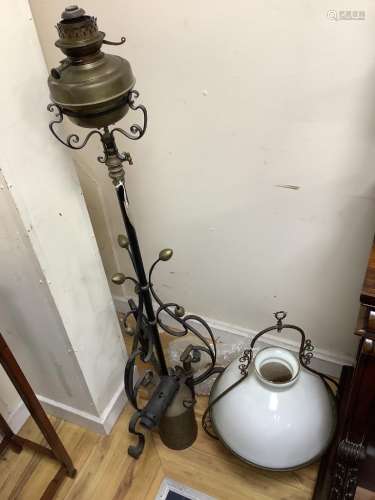 A wrought iron oil-fired floor lamp with reservoir and chimn...