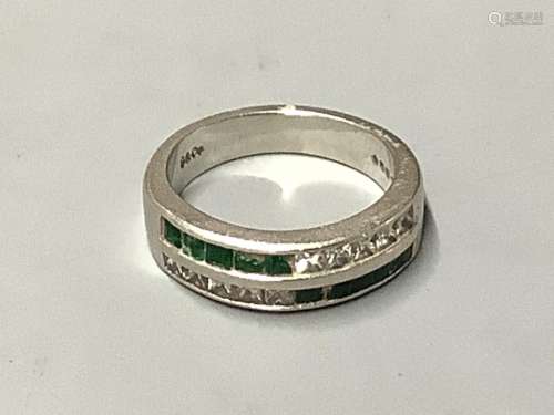 A platinum, emerald and diamond ring,channel set with two ro...