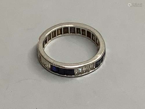 An 18ct white gold calibre-cut diamond and sapphire eternity...