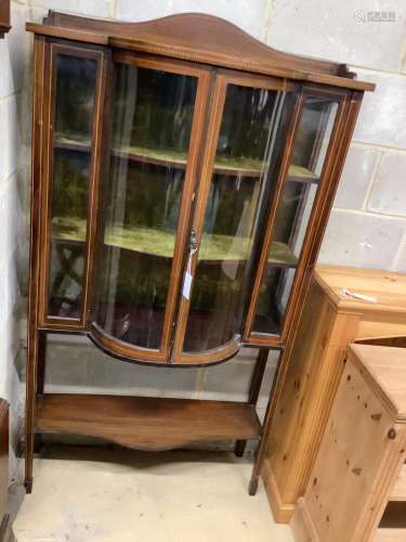 An Edwardian inlaid mahogany bow-fronted display cabinet, wi...