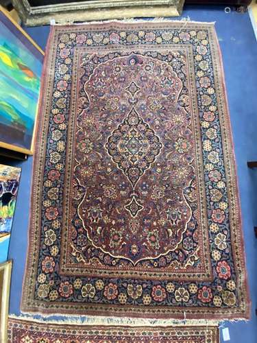 A Kashan burgundy ground rug, 208 x 135cm