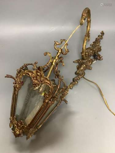 A brass hanging lantern and bracket
