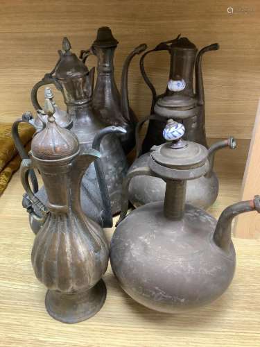 Seven Arabic tinned copper coffee pots, tallest being 34cm h...