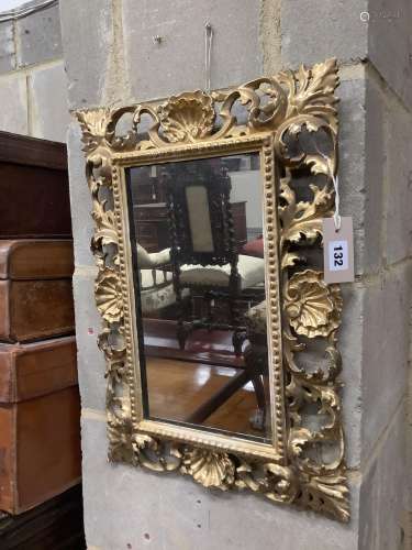 A Venetian foliate carved and pierced giltwood wall mirror, ...