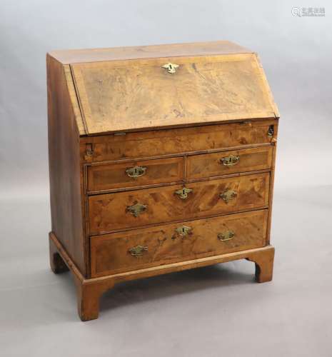 An early 18th century small walnut and crossbanded bureau, w...
