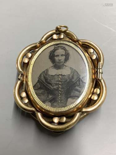 A Victorian pinchbeck and enamel revolving oval mourning bro...