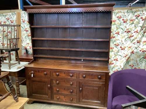 An early 19th century oak dresser with boarded rack, length ...