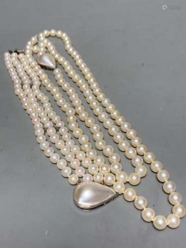 A single strand cultured pearl necklace, with a mother of pe...