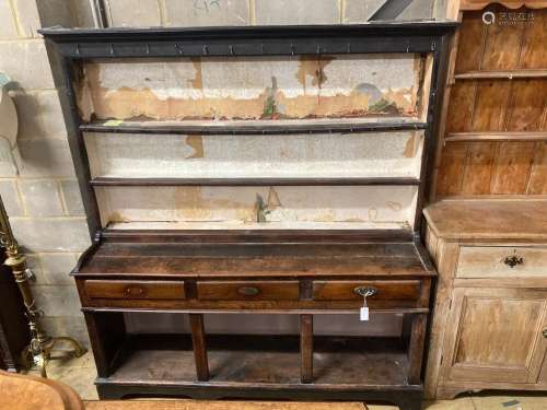 A George III oak dresser,the upper section fitted two shelve...