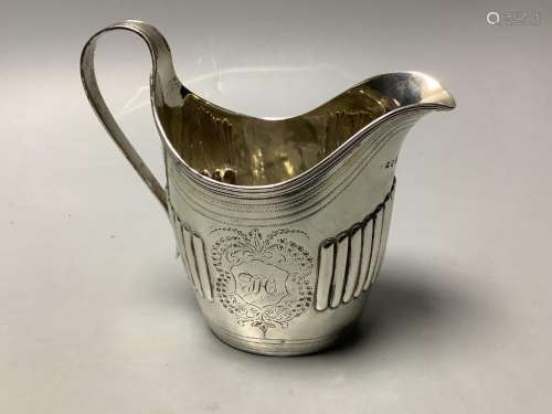 A George III part fluted silver oval cream jug, maker's mark...