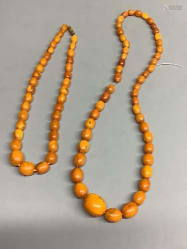Two single strand graduated oval amber bead necklaces, 60cm ...