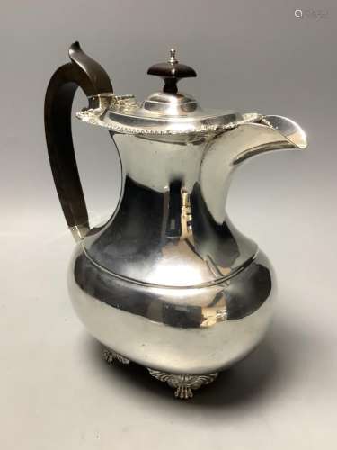 A London shape silver hot water pot with ebonised handle and...