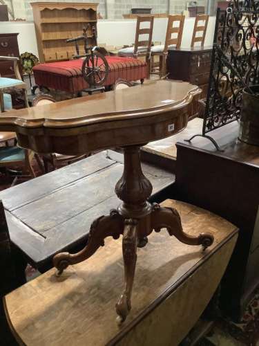A Victorian figured walnut serpentine folding card table, wi...