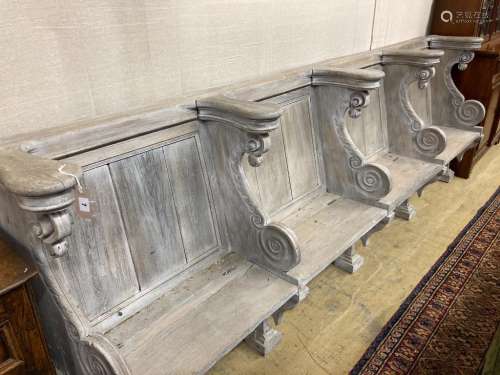 A 19th century limed carved oak four seat pew, length 300cm,...