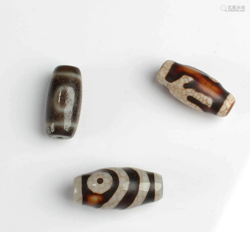 A Group of Three Dzi Beads