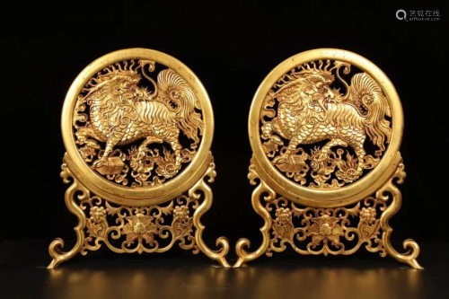 A pair of hand-engraved gilt unicorn screens from the
