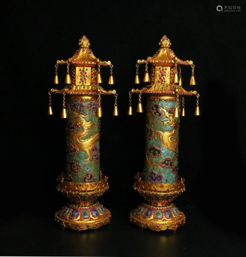 A pair of gilt pagodas inlaid with precious stones from