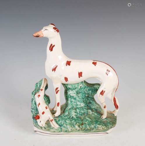 A 19th century Staffordshire pottery figure of hound and har...