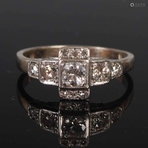 An Art Deco white metal and diamond set cocktail ring, centr...