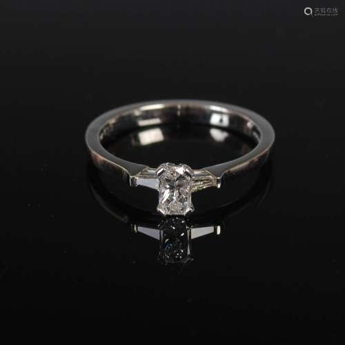 ANTWERP DIAMONDS, A platinum three stone diamond ring, centr...