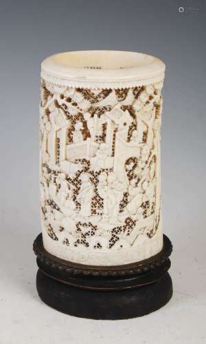 A Chinese ivory tusk vase, Qing Dynasty, carved with figures...
