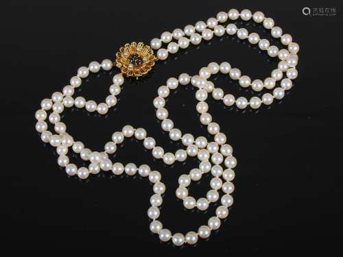 A two row cultured pearl necklet with an 18ct carat gold sap...