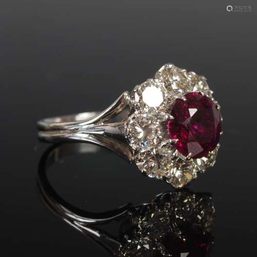 A white metal ruby and diamond cluster ring, circa 1970, cen...